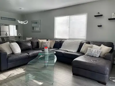 a living room with a couch and a glass table at Lovely 2 bedroom unit with a hot tub Pet friendly in Denver