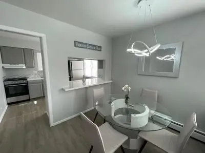 a dining room with a glass table and chairs at Lovely 2 bedroom unit with a hot tub Pet friendly in Denver