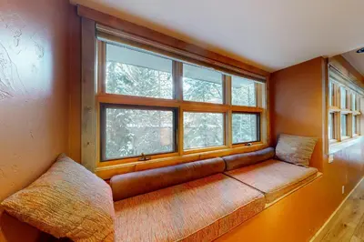 a couch sitting in a room with a window at Tenmile Mountain House in Frisco