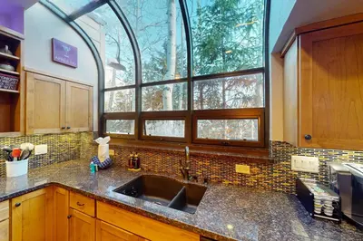 a kitchen with a sink and a large window at Tenmile Mountain House in Frisco