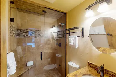 a bathroom with a shower and a sink and a mirror at Tenmile Mountain House in Frisco
