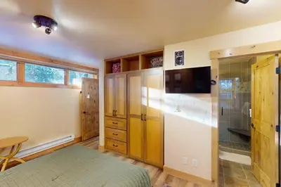 a bedroom with a bed and a glass shower at Tenmile Mountain House in Frisco