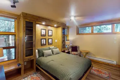 a bedroom with a bed in a room with windows at Tenmile Mountain House in Frisco