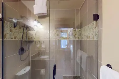 a shower with a glass door in a bathroom at Tenmile Mountain House in Frisco
