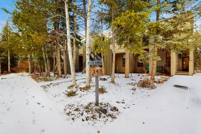 a house with a speed limit sign in the snow at Tenmile Mountain House in Frisco