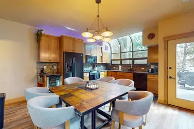 a kitchen with a dining room table and chairs at Tenmile Mountain House in Frisco