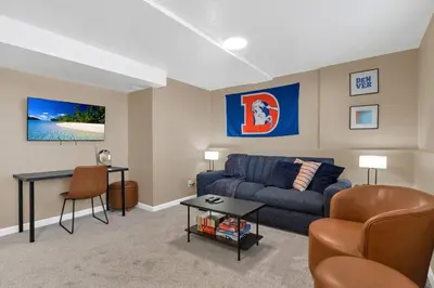 a living room with a couch and a table at 5 Bed/ Pickle360/ Basketball/ Movie in Thornton