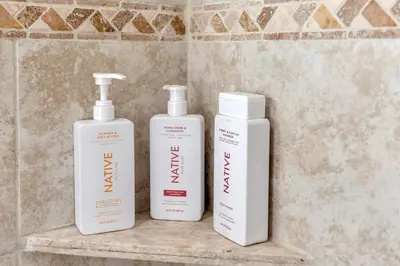 three bottles ofodorizers sitting on a shelf in a bathroom at 5 Bed/ Pickle360/ Basketball/ Movie in Thornton