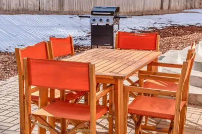 a wooden table with four chairs and a stove at 5 Bed/ Pickle360/ Basketball/ Movie in Thornton
