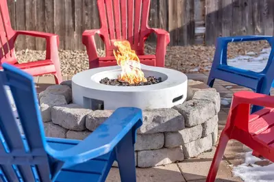 a fire pit in a yard with colorful chairs at 5 Bed/ Pickle360/ Basketball/ Movie in Thornton