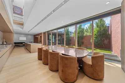 a dining room with a glass table and chairs at LoHi Luxury Modern House — Walk to Everywhere in Denver