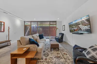a living room with a couch and a tv at LoHi Luxury Modern House — Walk to Everywhere in Denver