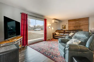 a living room with a couch and a flat screen tv at 3 Mi to Dtwn Berthoud Home with Longs Peak Views in Berthoud