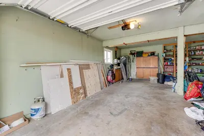 an empty garage with a room with doors and shelves at 3 Mi to Dtwn Berthoud Home with Longs Peak Views in Berthoud