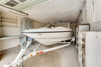 a boat is parked in a garage at 3 Mi to Dtwn Berthoud Home with Longs Peak Views in Berthoud