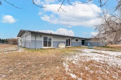 a house with a yard in front of it at 3 Mi to Dtwn Berthoud Home with Longs Peak Views in Berthoud