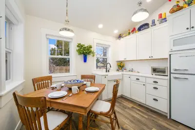 a kitchen with a wooden table and chairs at City Park Bungalow Pet Friendly with Dog Run in Fort Collins