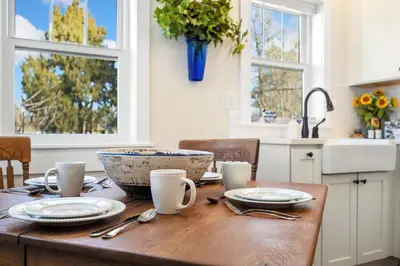a kitchen with a wooden table with a bowl on it at City Park Bungalow Pet Friendly with Dog Run in Fort Collins
