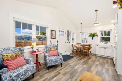 a kitchen and living room with two chairs and a table at City Park Bungalow Pet Friendly with Dog Run in Fort Collins