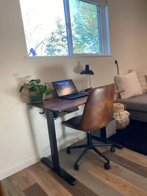 a desk with a laptop computer on it in a room at Apartment in Ft Collins in Fort Collins