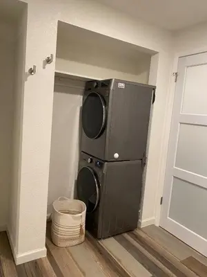 a washer and dryer in a corner of a room at Apartment in Ft Collins in Fort Collins