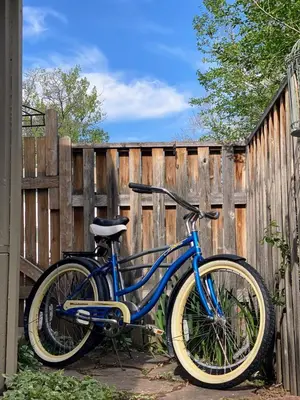 a blue bike parked next to a wooden fence at Apartment in Ft Collins in Fort Collins