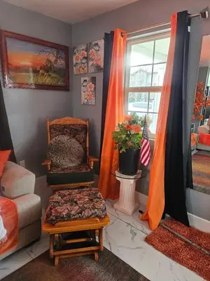 a living room with a chair and a window at 3BR Lakewood • Free Parking + BBQ • Near Red Rocks in Lakewood