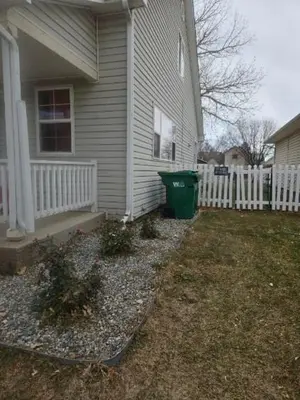 a house with a green trash can in the yard at 3BR Lakewood • Free Parking + BBQ • Near Red Rocks in Lakewood