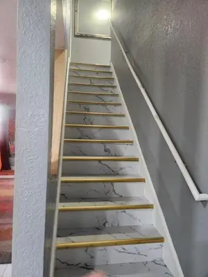 a metal staircase with marble floors in a room at 3BR Lakewood • Free Parking + BBQ • Near Red Rocks in Lakewood