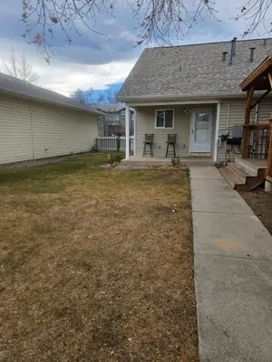 a house with a porch with a picnic table in the yard at 3BR Lakewood • Free Parking + BBQ • Near Red Rocks in Lakewood