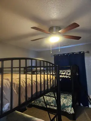 a bedroom with a ceiling fan and a bunk bed at 3BR Lakewood • Free Parking + BBQ • Near Red Rocks in Lakewood
