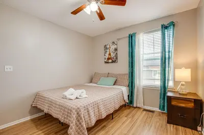 a small bedroom with a bed and a ceiling fan at Spacious Family Home at Buckley SFB with Patio! in Aurora
