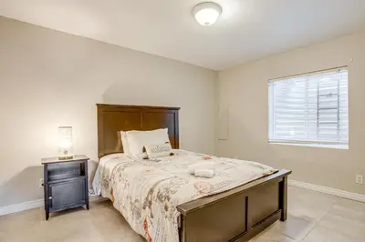 a bedroom with a large bed and a window at Spacious Family Home at Buckley SFB with Patio! in Aurora
