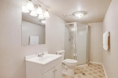 a bathroom with a toilet and a sink and a shower at Spacious Family Home at Buckley SFB with Patio! in Aurora