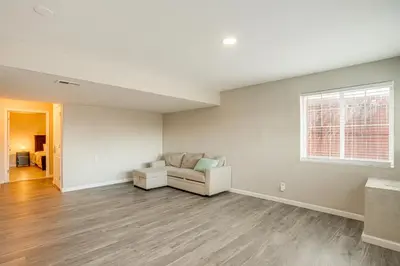 a living room with a couch and a window at Spacious Family Home at Buckley SFB with Patio! in Aurora
