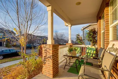 a porch with two chairs and a table on a house at Spacious Family Home at Buckley SFB with Patio! in Aurora