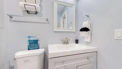 a white bathroom with a sink and a toilet at Family Home in Arvada with king beds and bunkbed in Arvada