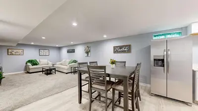 a kitchen and dining room with a table and a refrigerator at Family Home in Arvada with king beds and bunkbed in Arvada