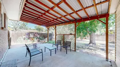 a covered patio with chairs and a table at Family Home in Arvada with king beds and bunkbed in Arvada