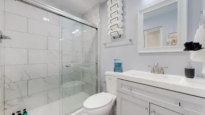 a bathroom with a shower and a toilet and a sink at Family Home in Arvada with king beds and bunkbed in Arvada