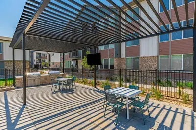 a patio with a table and chairs and a tv at Landing Incredible 2BD Clubhouse Gym in Longmont
