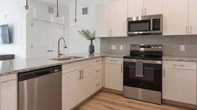 a kitchen with white cabinets and stainless steel appliances at Landing Incredible 2BD Clubhouse Gym in Longmont