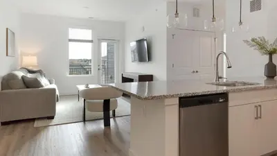 a white kitchen with a sink and a counter at Landing Incredible 2BD Clubhouse Gym in Longmont