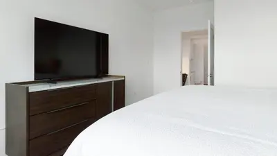 a bedroom with a bed with a flat screen tv at Landing Incredible 2BD Clubhouse Gym in Longmont