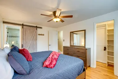 a bedroom with a blue bed and a ceiling fan at Gather Family! Home with Fenced Yard in Wheat Ridge in Wheat Ridge