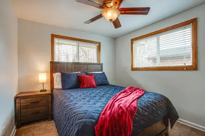 a bedroom with a bed and a ceiling fan at Gather Family! Home with Fenced Yard in Wheat Ridge in Wheat Ridge