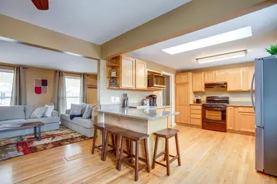 an open kitchen and living room with a couch at Gather Family! Home with Fenced Yard in Wheat Ridge in Wheat Ridge