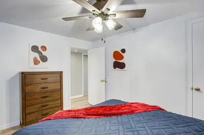 a bedroom with a ceiling fan and a bed at Gather Family! Home with Fenced Yard in Wheat Ridge in Wheat Ridge