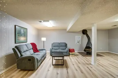 a living room with a couch and two chairs and a fireplace at Gather Family! Home with Fenced Yard in Wheat Ridge in Wheat Ridge