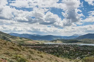 a town on a hill with a lake and mountains at 10-Person HotTub, ViewHouse, Steps to Trail, Close to Ski Resorts, FirePit in Silverthorne